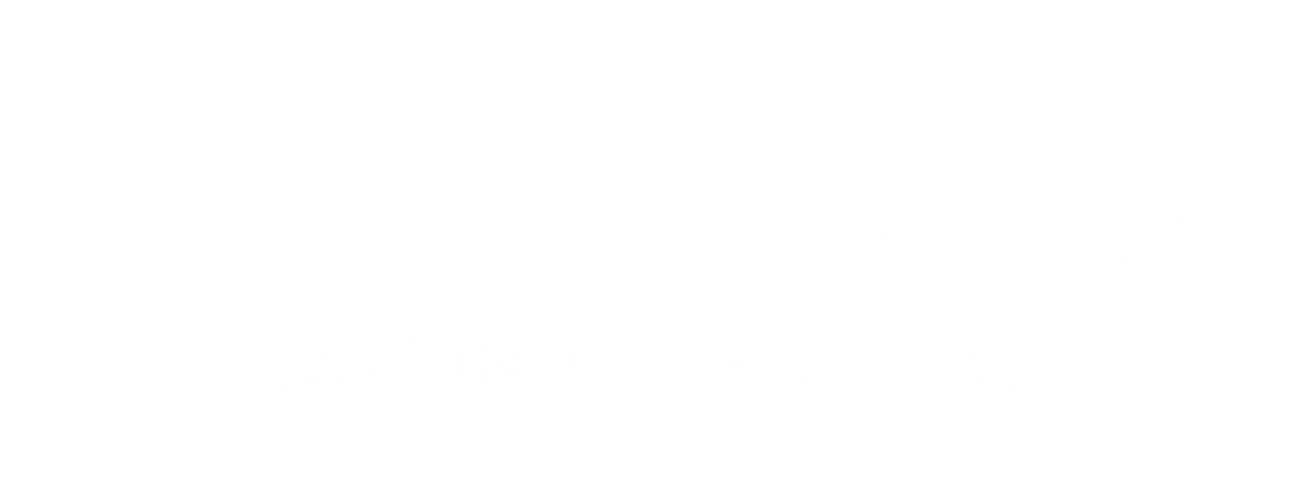 A sign that says "REO FLATS" in green on a white background.